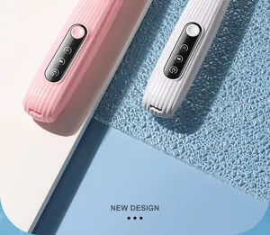 Detail shot of pink and white electric pet hair trimmers showing panel and texture