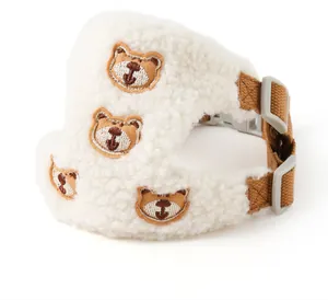 Detailed view of plush lamb wool dog harness with cute embroidered bear face patches