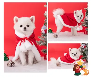 Detailed view of red and white Christmas dog cloak with decorative white pom-poms