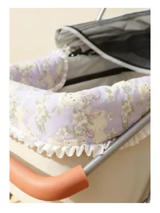 Detail shot of purple floral pet stroller bumper pad with cute bunny and white ruffles.