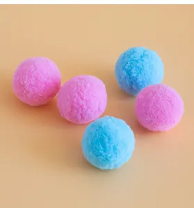 Close-up of colorful soft plush pom-pom cat toys in vibrant pink and bright blue colors