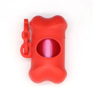 Detailed view of bone-shaped red pet waste bag dispenser with internal pink bag roll