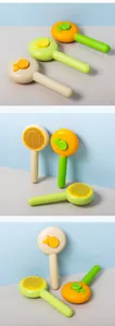 Detailed view of self-cleaning pet brushes with stainless steel pins in fruit-inspired colors
