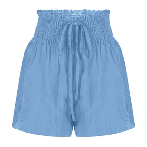 Close-up of light blue summer shorts showing smocked high waist and drawstring detail