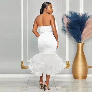 Vista trasera de un elegante vestido sirena palabra de honor blanco con volantes de tul y lazo