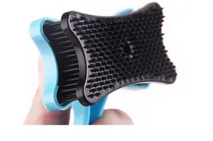 Close-up of black bristles on a blue pet grooming brush for de-shedding dogs and cats.