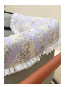 Close-up of a purple floral bunny print pet stroller bumper pad with ruffled edges