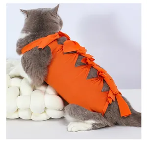Detail of an orange cat recovery suit with ribbon straps for post-surgery protection.