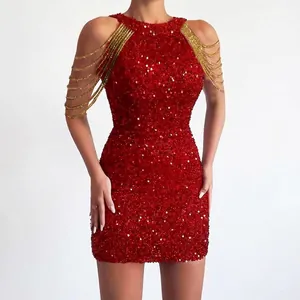 Close-up detail of a red sequined bodycon dress with elegant gold shoulder chains.