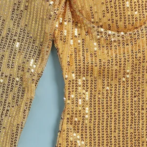 Detailed close-up showing shimmering gold sequins on a glamorous evening party dress