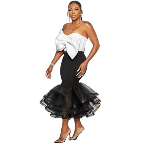 Elegante conjunto de dos piezas con top de lazo blanco y falda sirena de tul negro