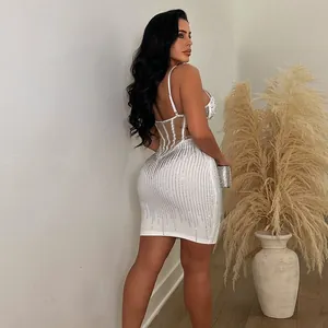 Elegant white bodycon mini dress with rhinestone pearls and corset sheer back details