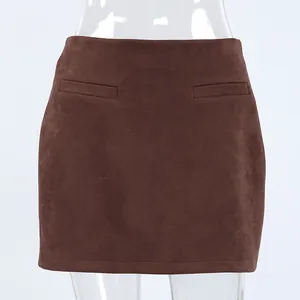 Detail view of brown suede high waist mini skirt with decorative pockets
