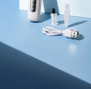 Detail view of pet electric shaver accessories including USB cable, brush, and oil.