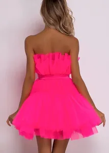 Back view of a vibrant hot pink strapless mesh tutu dress with layered tulle skirt.