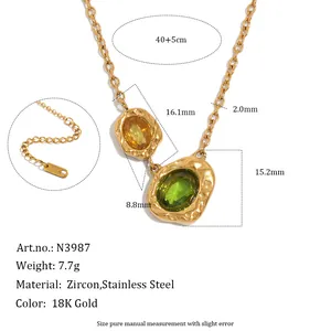 Detail view of vintage 18K gold plated stainless steel necklace with green zircon