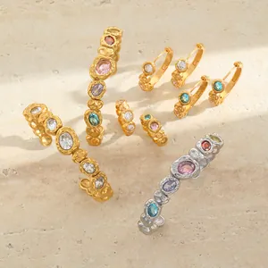 Detailed close-up of hammered 18K gold-plated jewelry with colorful inlaid gemstones