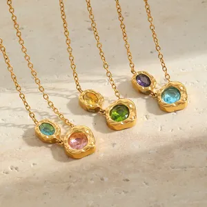 Detail view of vintage 18K gold plated hammered necklaces with vibrant colored stones