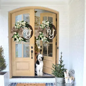 Artificial tulip door wreath with white letter Y decoration on a wooden front door