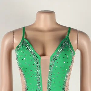 Close-up detail of sexy green rhinestone camisole dress with sheer mesh and V-neckline