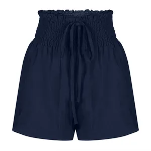 Detailed view of navy blue high-waisted smocked shorts with functional drawstring