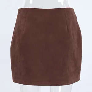 Close-up detail of retro brown suede mini skirt with high waist and bodycon fit