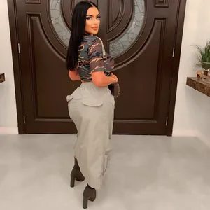 Model wearing a sexy grey cargo mini skirt with zipper pockets in an indoor setting