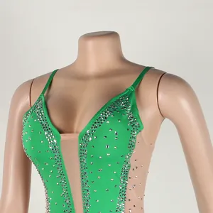 Detail of sexy green mesh bodysuit with sparkling silver rhinestones and camisole straps.