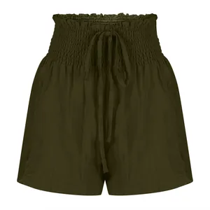 Detailed macro view of olive green smocked waist shorts with an adjustable drawstring.