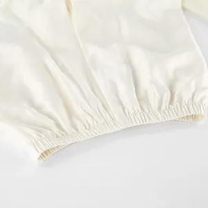 Close-up of the elastic waistband detail on white tencel fabric with ruffled gathering