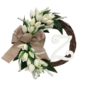 Detailed view of artificial white tulip wreath with burlap bow and wooden letter Z ornament