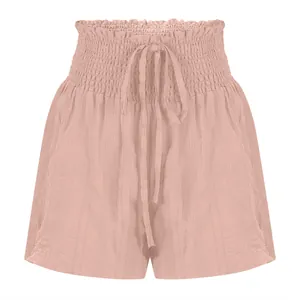 Detailed macro view of pink smocked high-waisted drawstring summer shorts for women