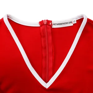 Detail of a red professional dress showing the V-neckline white trim and back zipper