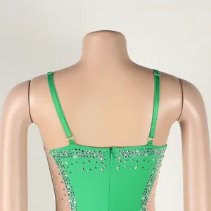 Detail of back on a green rhinestone spaghetti strap dress featuring sheer mesh side panels