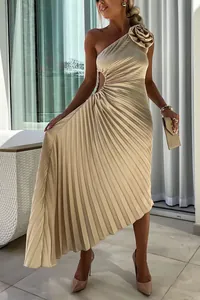Elegant champagne pleated one-shoulder dress detail showing floral applique and waist cutout