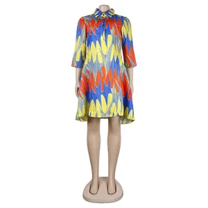 Full view of a colorful vibrant print shirt dress with V-neck and collar on a mannequin