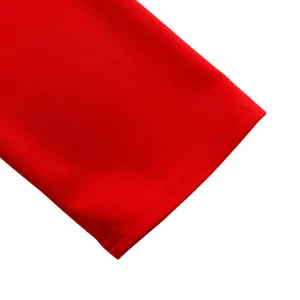 Close-up detail of red long sleeve cuff stitching on a professional pencil dress