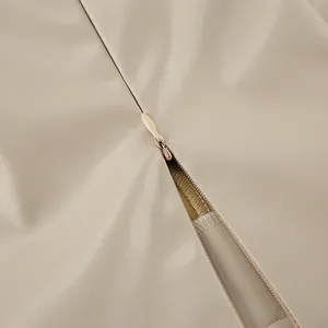 Close-up of invisible zipper and soft PU leather texture on khaki skirt