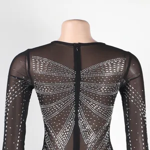 Macro detail of the sparkling silver rhinestone butterfly pattern on black mesh.