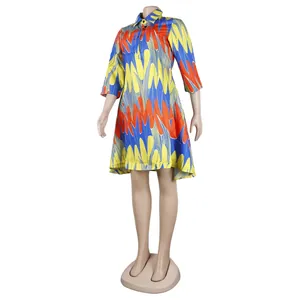 Macro view of colorful abstract pattern shirt dress with buttoned collar and three-quarter sleeves