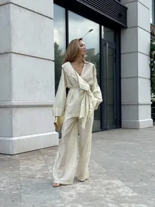 Elegant cream Tencel two-piece set with ruffled wrap top and wide-leg trousers for autumn