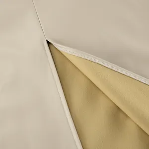 Close-up of khaki PU leather skirt with soft yellow fleece lining and slit detail