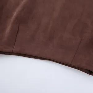 Macro view of the soft brown suede fabric texture and fine stitching on a vintage skirt