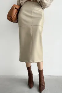 Detail of a khaki PU leather midi skirt with seam stitching and a hip-hugging fit