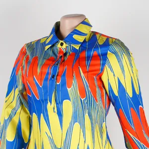 Close-up detail of the vibrant abstract wavy pattern on a slim fit colorful lapel shirt dress