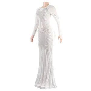 Detailed view of an elegant white floor-length evening gown with rhinestone patterns.