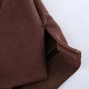 Detail macro shot of hidden side zipper on brown vintage suede-like high-waist mini skirt