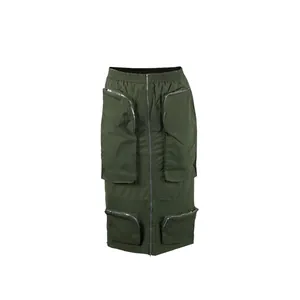 Detail of army green cargo midi skirt with multiple zipper pockets and central zip