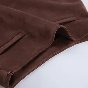 Detailed macro view of high-quality brown suede fabric and hidden zipper on skirt