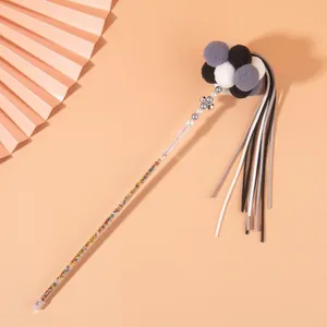 Detail of a luxury cat teaser wand featuring colorful beads, soft pom-poms, and long tassels